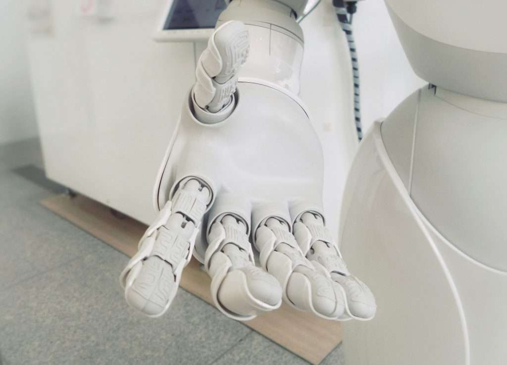 Collaborative advanced robotic hand symbolizing exploring AI tools together with beginner users via ToolWillIt