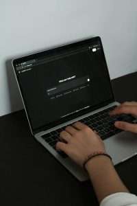 User typing on laptop using ChatGPT AI chatbot, beginner learning AI tools with ToolWillIt guide
