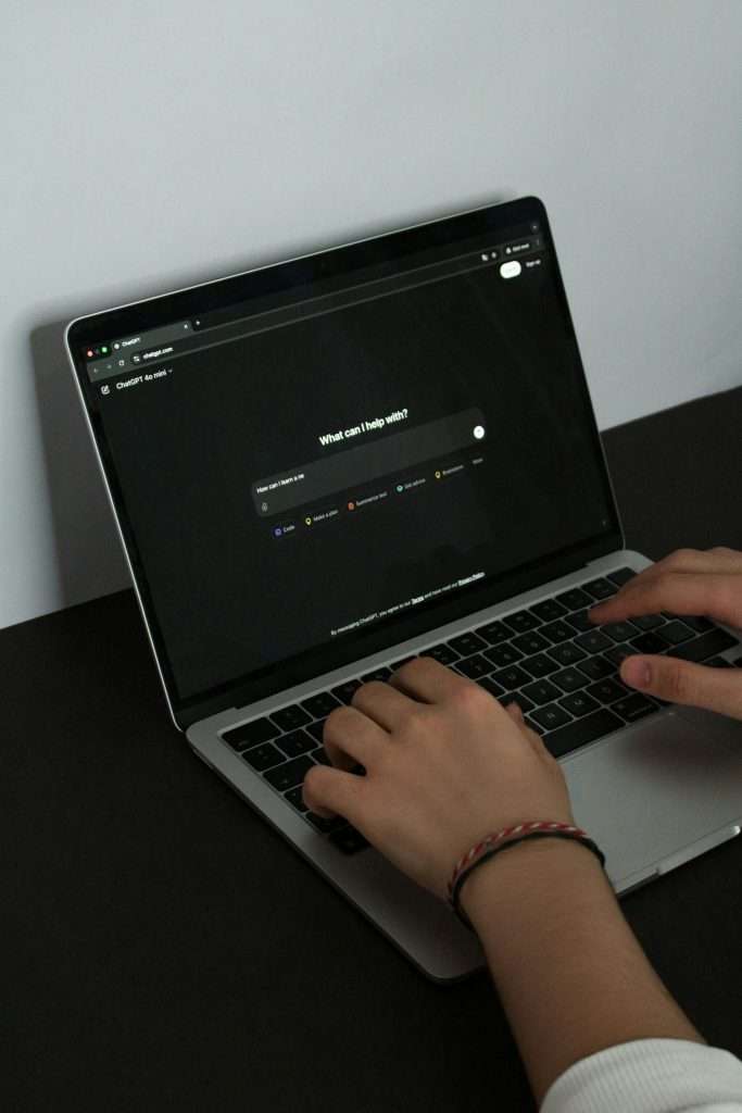 User typing on laptop using ChatGPT AI chatbot, beginner learning AI tools with ToolWillIt guide