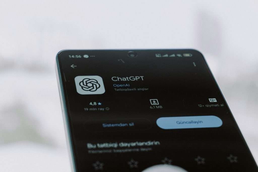 Mobile phone screen showing ChatGPT OpenAI app store download page for AI prompt writing