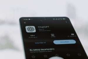 Mobile phone screen showing ChatGPT OpenAI app store download page for AI prompt writing